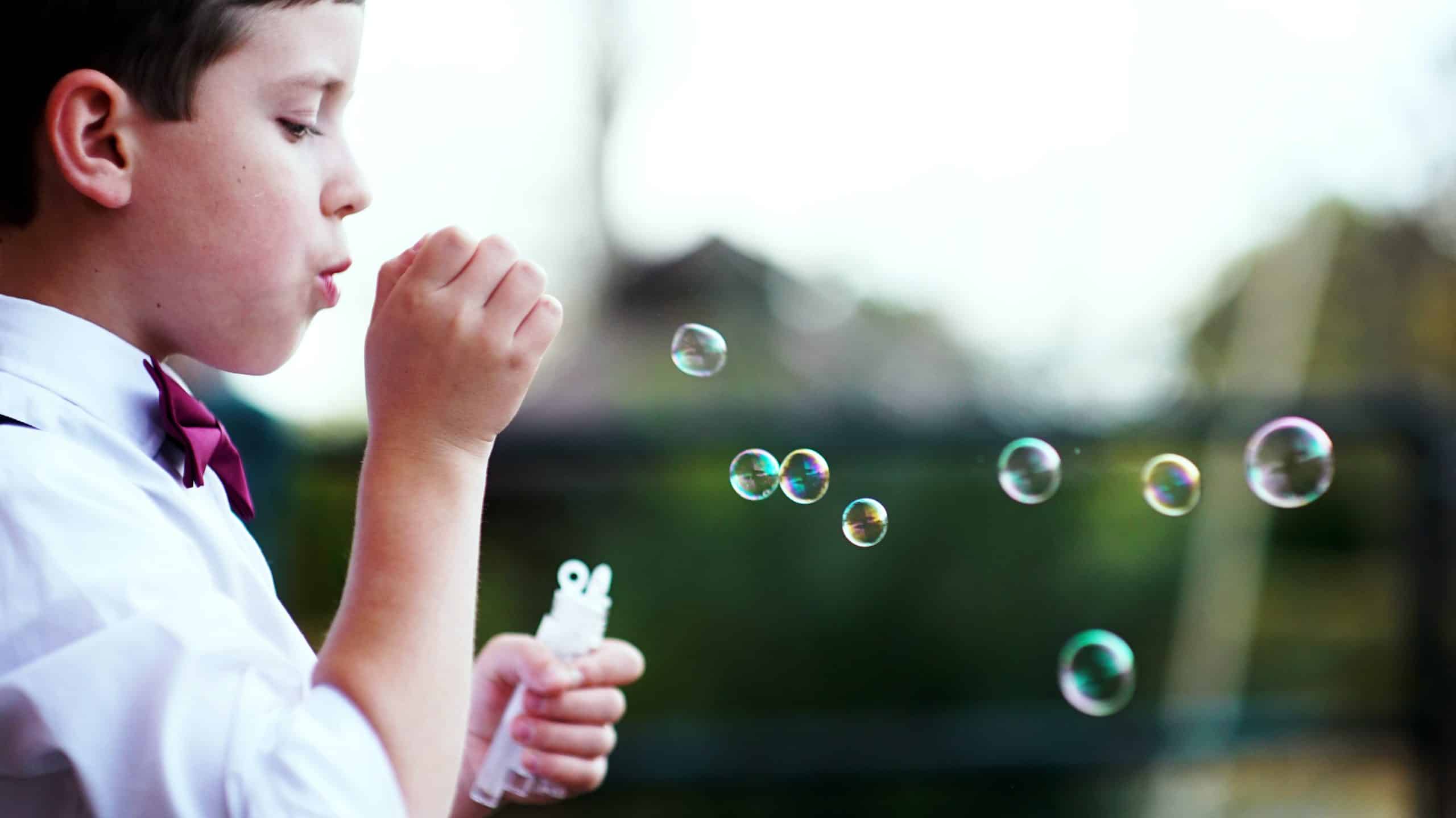 boy with enuresis and ADHD blows bubbles