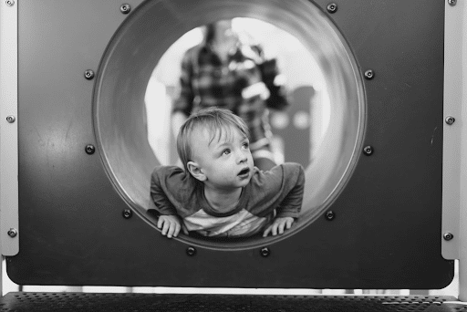 boy playing in tunnel
