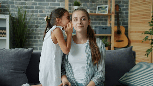 child telling secret
