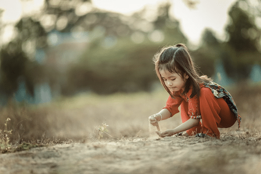 girl playing in sand
